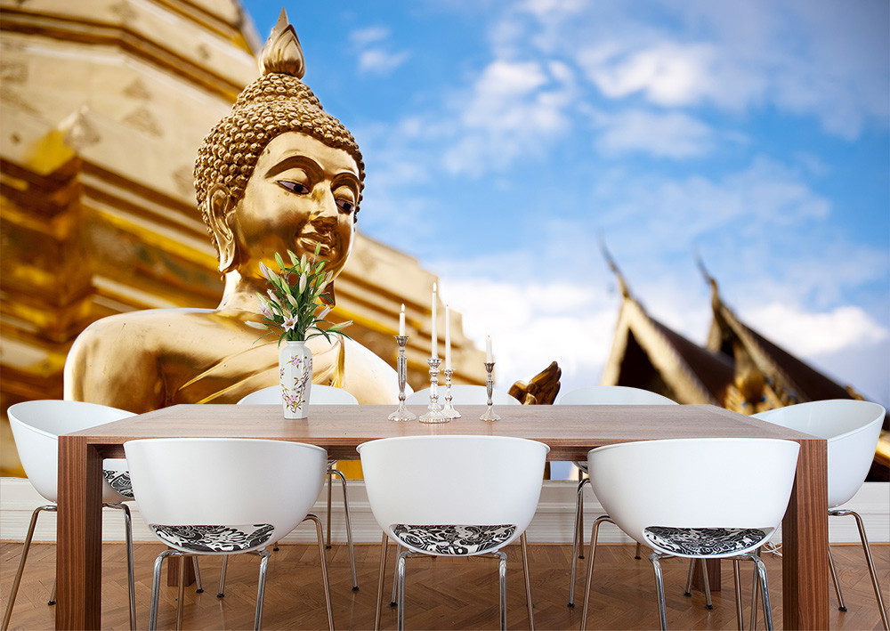 Wall mural - Large golden Buddha statue and traditional roof against a blue sky, ideal for dining room decoration