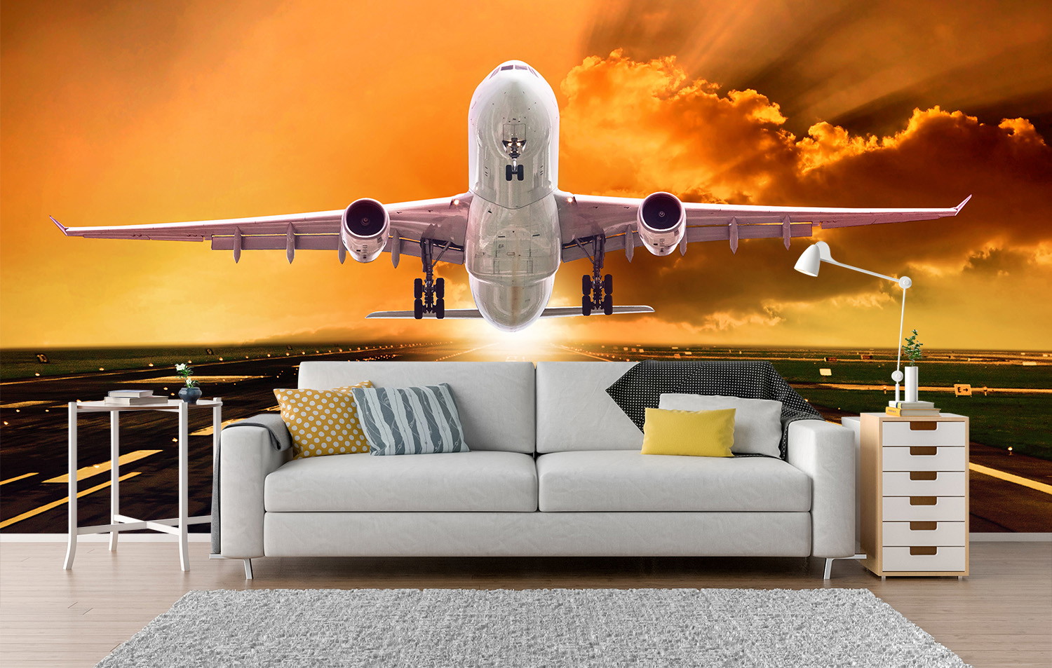 Wall mural - A large aeroplane landing on a runway under a dramatic sunset sky in the living room.