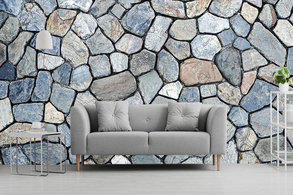 Wall mural - Grey sofa in front of a wall with stone-like wallpaper, modern table and lamp