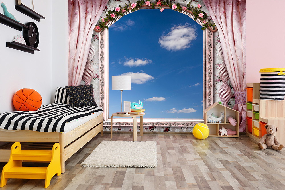Wall mural - nursery with bed, toys and view of blue sky through decorative pink framed window