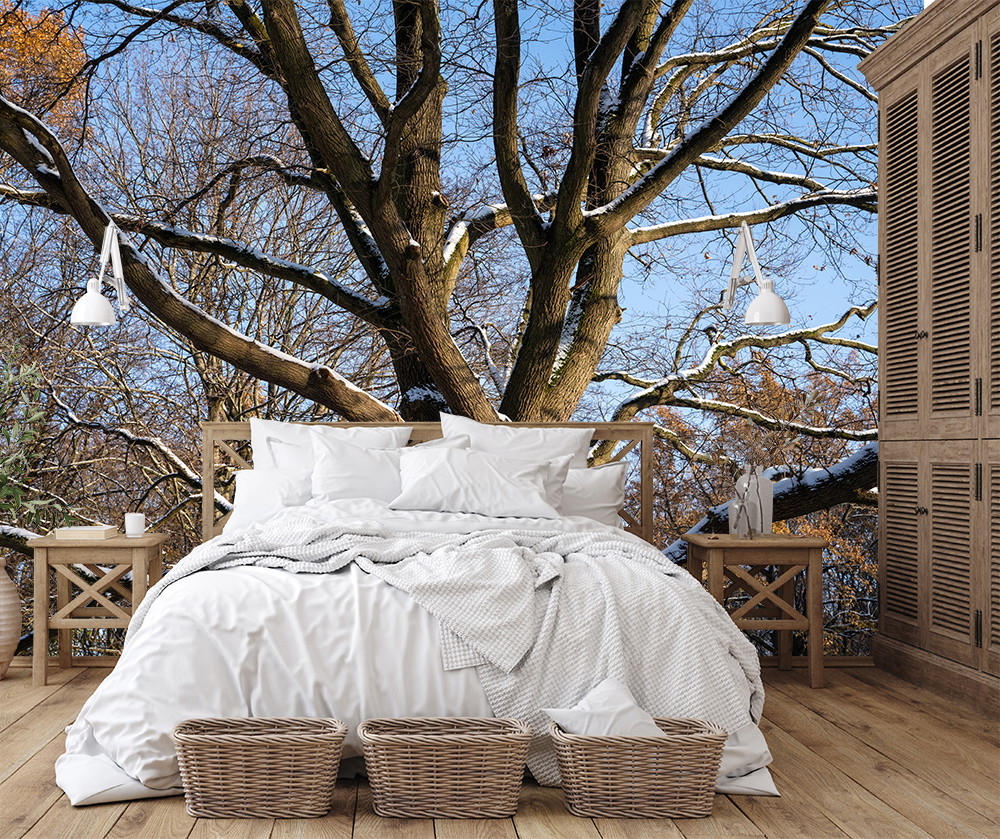 Fototapete - Helles Schlafzimmer mit großem Baum im Schnee als Hintergrund und gemütlichem Ambiente