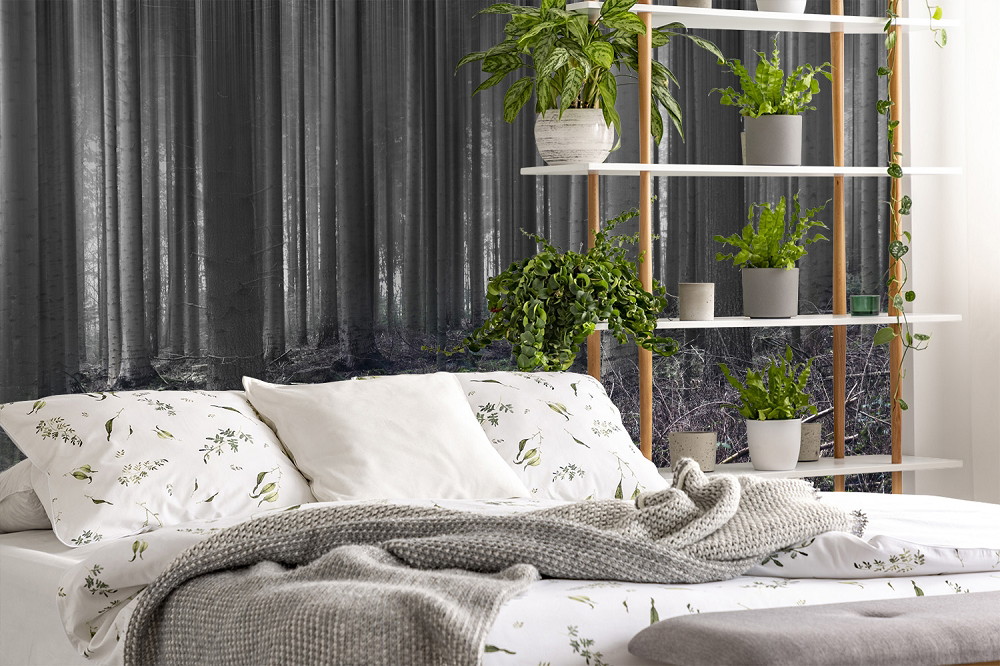 Wall mural - Bedroom with decorative forest wallpaper and green plant decor