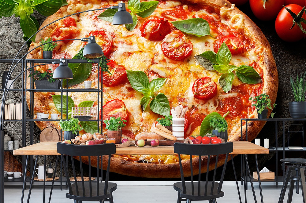 Wall mural - Large pizza motif with tomatoes and basil in a stylish kitchen