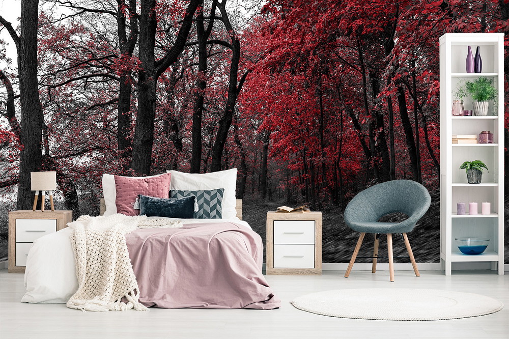 Wall mural - Modern furnished bedroom with a wall decoration of red and black forest trees
