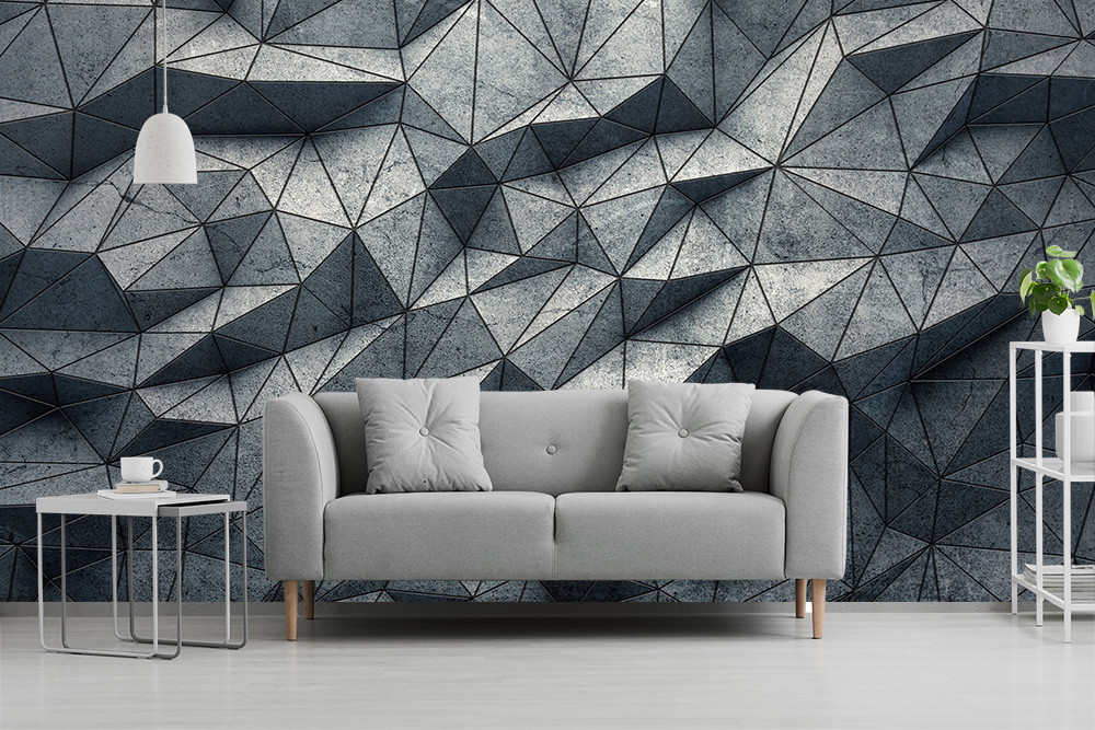 Wall mural - Grey, geometric pattern wall behind a sofa area with cushions and lamps