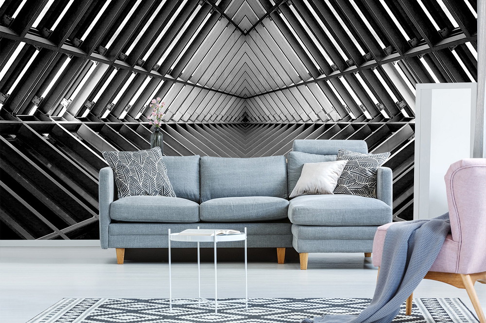 Fotobehang - Zwart-witte geometrische architectuur als stijlvolle achtergrond achter een moderne bank in de woonkamer