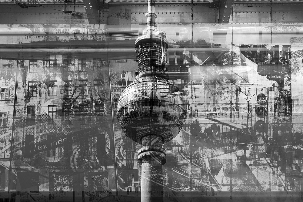 Wall mural - Artistic depiction of the Berlin television tower in front of an urban cityscape in black and white