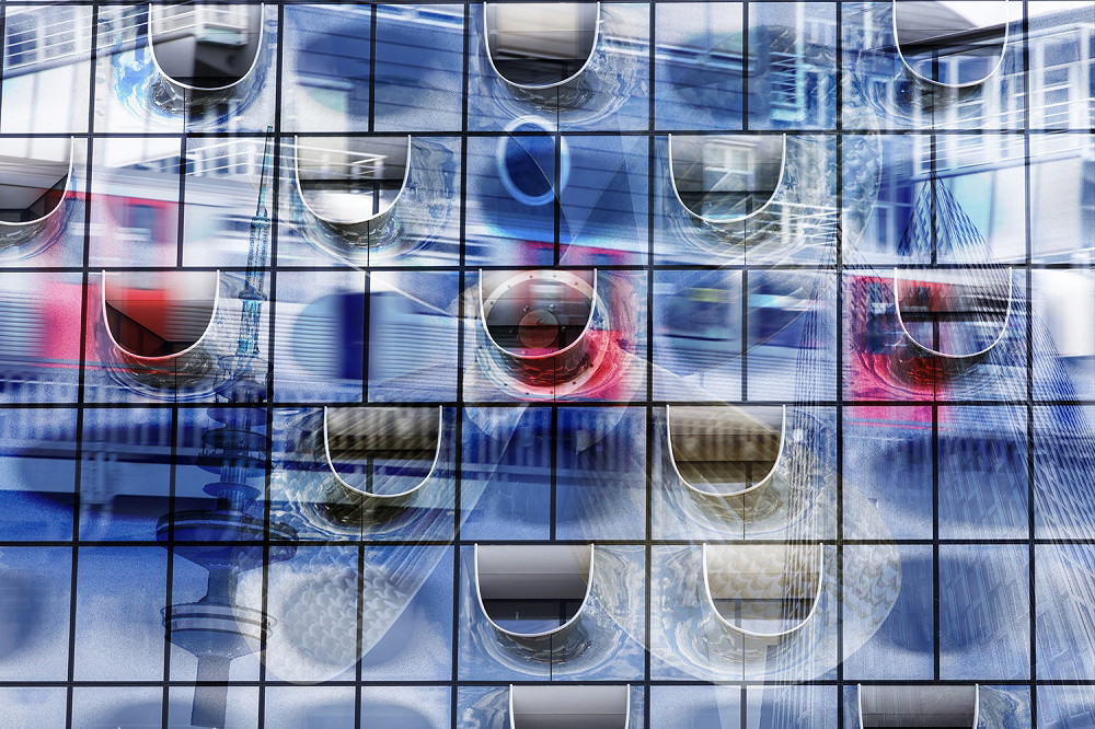 Wall mural - Detail of a modern glass façade with colourful reflections and abstract shapes