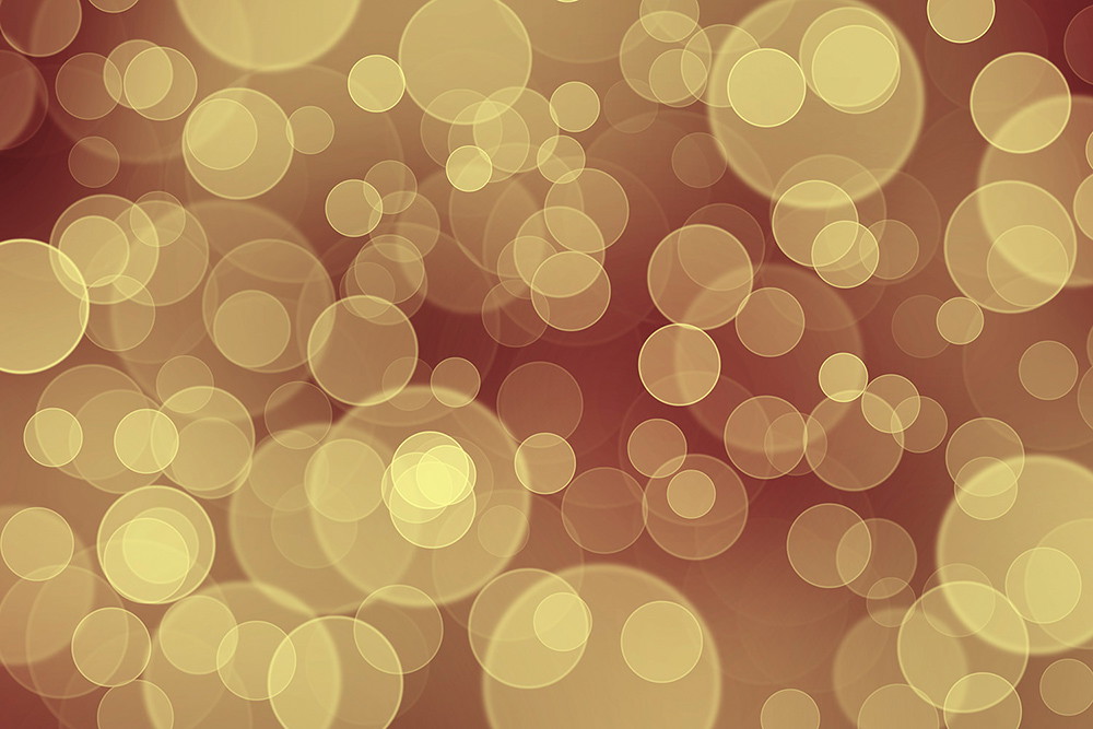 Fototapeta ścienna - Abstrakcyjny wzór bokeh z miękkimi, żółtymi kropkami światła na brązowym tle