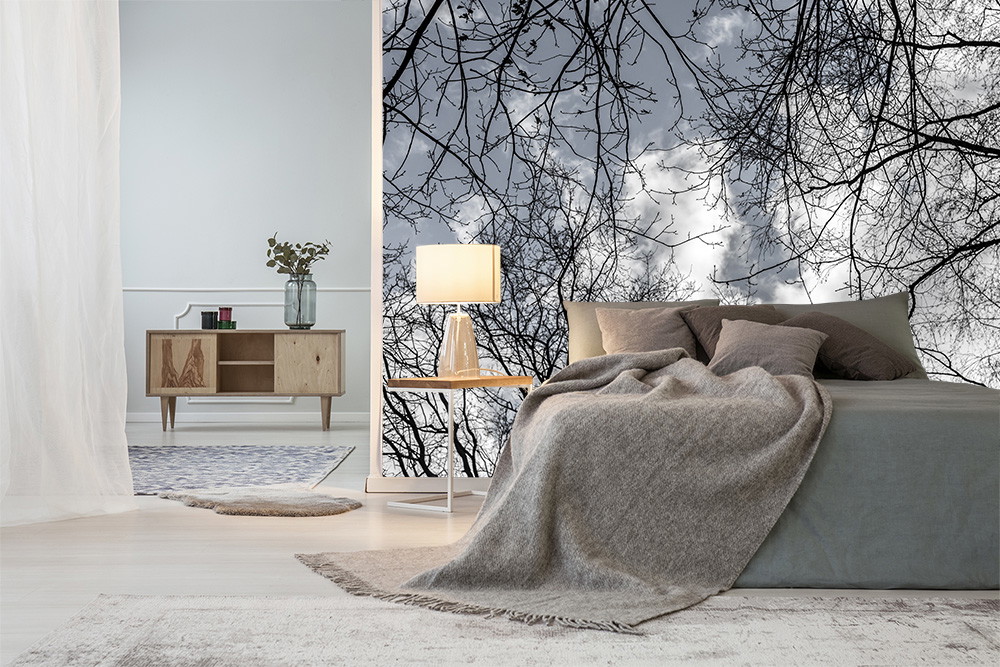 Wall mural - Modern furnished bedroom with bed, lamp and wallpaper with branch motif