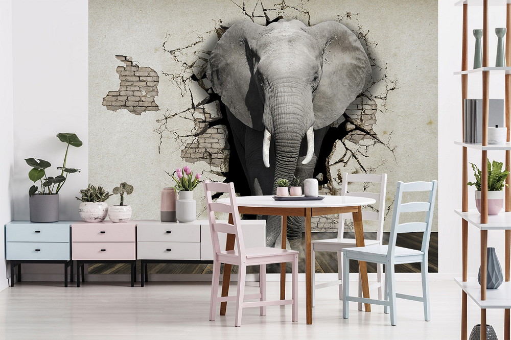 Wall mural - An elephant breaks through a wall, surrounded by a stylish room with plants and furniture.