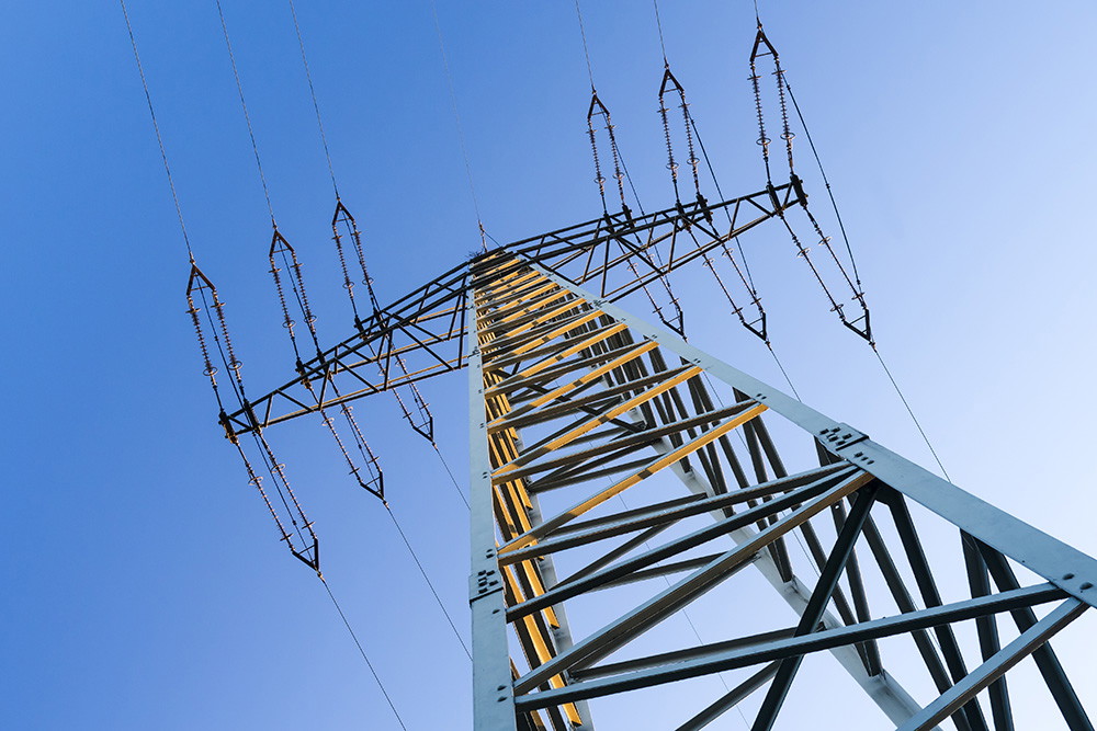 Wall mural - View of an electricity pylon against the blue sky