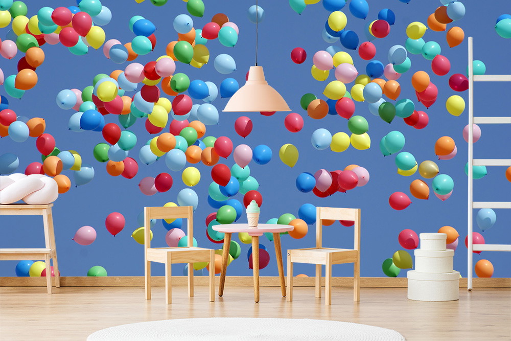 Papier peint photo - Des ballons lumineux et colorés flottent devant un mur bleu dans une pièce élégante avec une table et des chaises