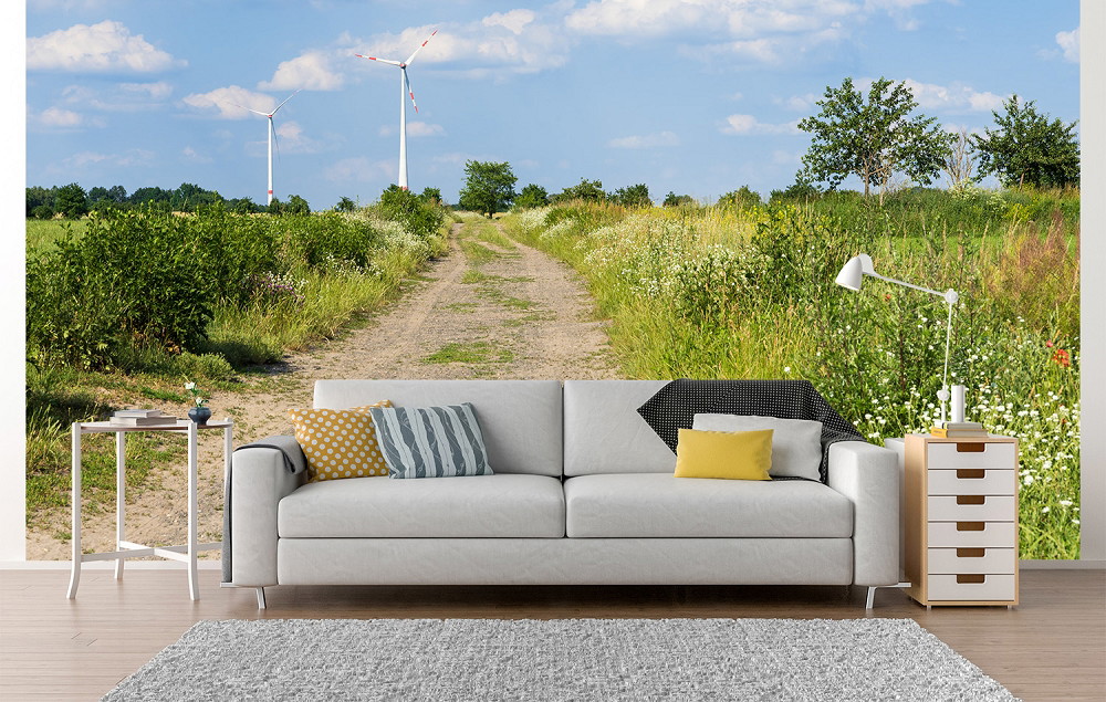 Fototapete - Landschaft mit Windkraftanlagen und Feldweg hinter einem Sofa im Wohnzimmer