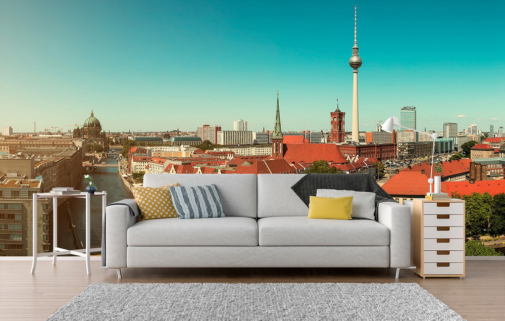 Wall mural - Living room with a view of Berlin's skyline including the TV tower, decorated with modern furniture
