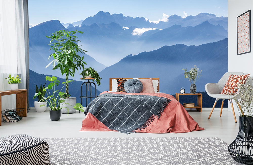 Wall mural - Modern bedroom with mountain landscape, plants and cosy furnishings