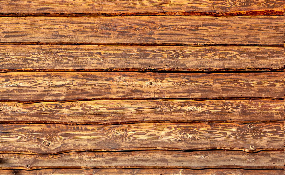 Muurschildering - Close-up van een rustieke houten muur met zichtbare houtnerf en warme kleuren