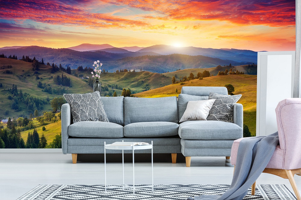 Wall mural - Modern living room with grey sofa and wall mural of a colourful sunset over a hill panorama