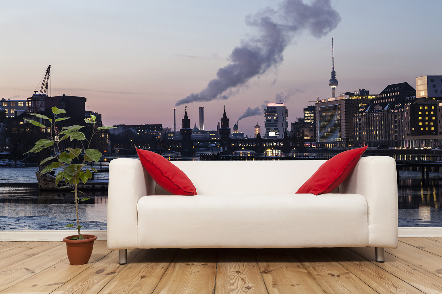 Papier peint photo - Panorama d'une ville au coucher du soleil avec un canapé et une plante dans la pièce