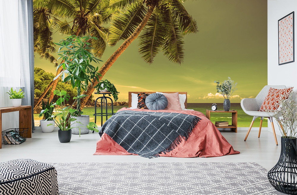 Wall mural - Cosy bedroom with wall mural of a tropical beach with palm trees and sea views.