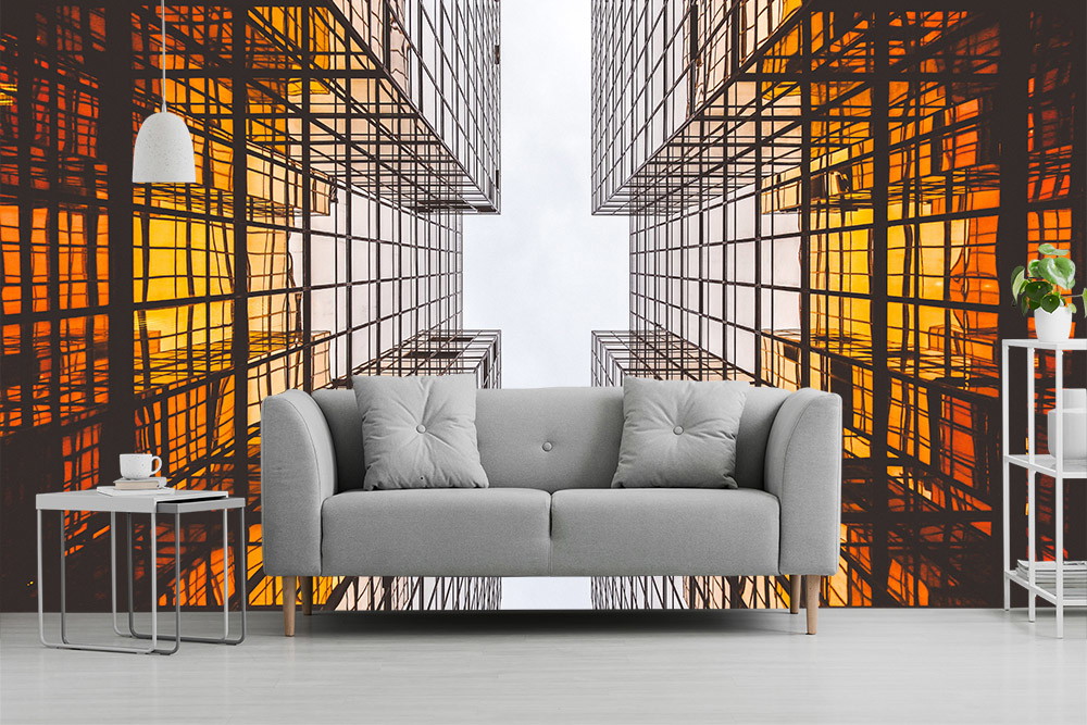 Fotobehang - Uitzicht op oranje verlichte glazen gebouwen met een moderne bank op de voorgrond
