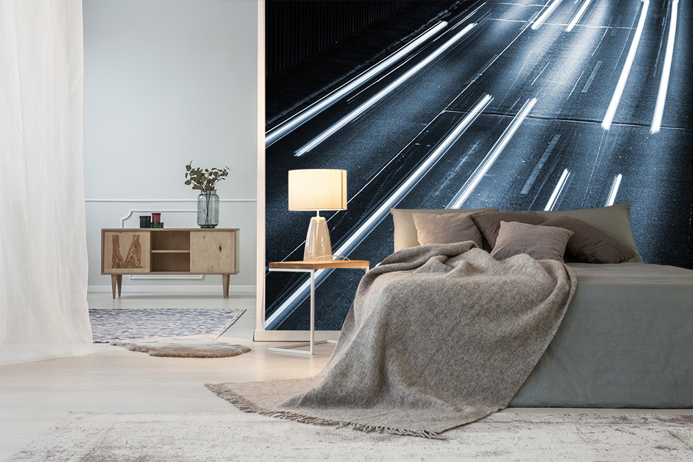 Wall mural - bed with ceiling in a room with a black and white wall mural showing a motorway with lanes of lights