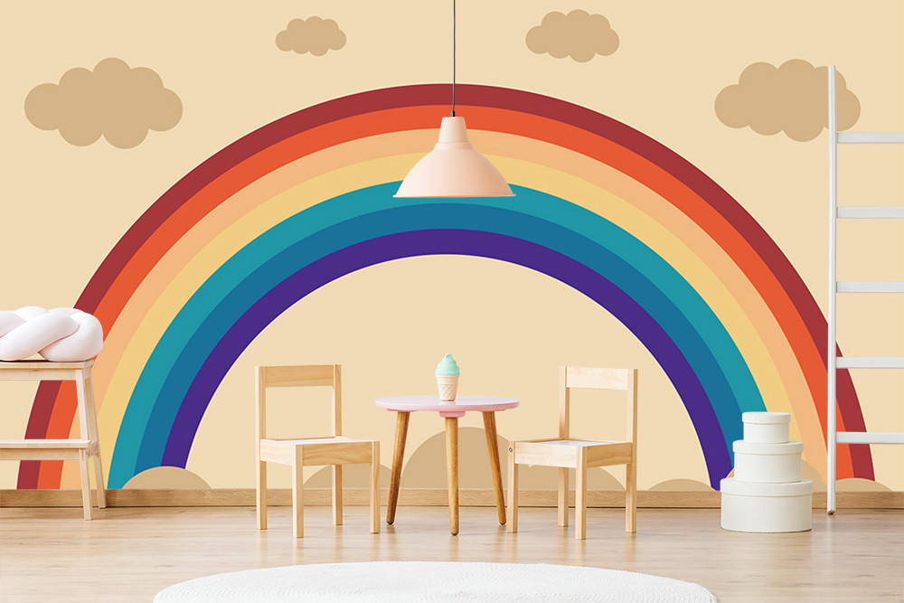 Wall mural - Colourful rainbow wall mural in a children's room, decorated with clouds and a table with chairs.