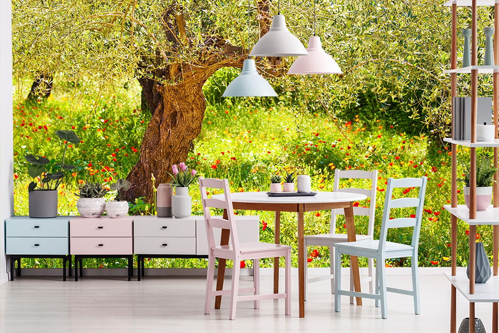 Wall mural - Bright dining room decoration with table, chairs and wallpaper of an olive tree and blossoming landscape