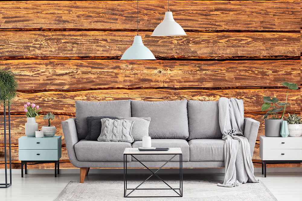 Fototapete - Wohnzimmer mit grauem Sofa, Holztapete, blauen Beistelltischen und hängenden Lampen