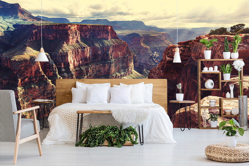 Wall mural - Bedroom with wall mural of an impressive canyon landscape, wooden bed and houseplants