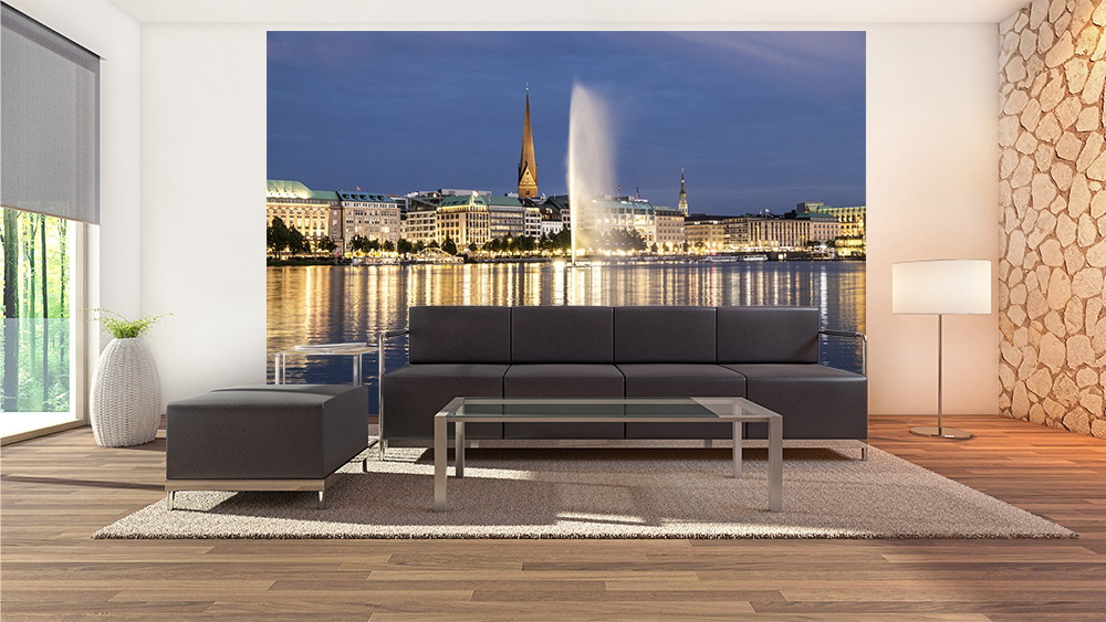 Wall mural - Elegant living room with panoramic wallpaper of an illuminated city by the water at dusk