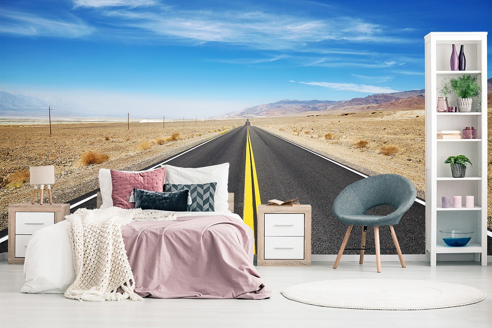 Fotomurale - Camera da letto con strada del deserto come murale, decorata con letto, comodini e sedia
