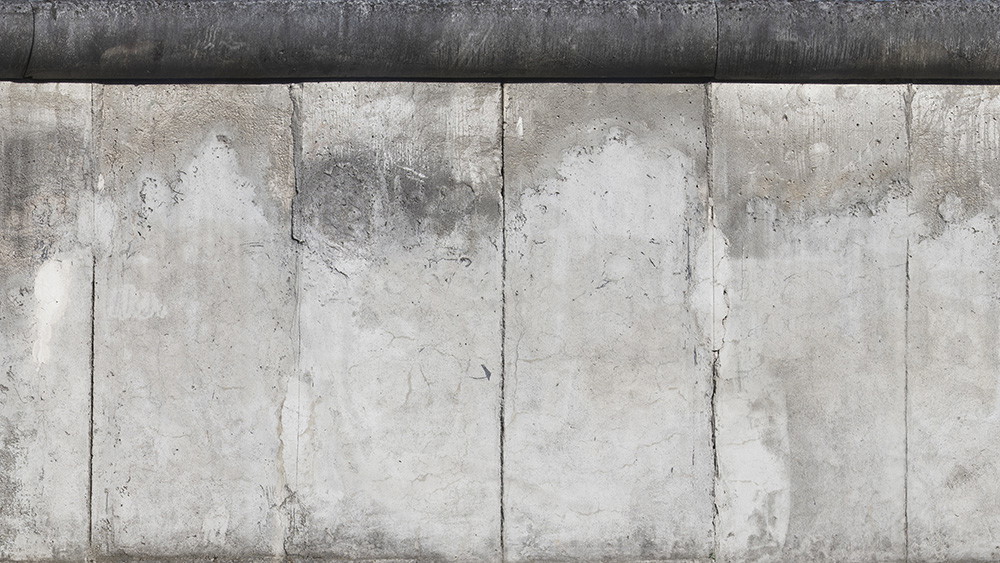 Wall mural - Detailed view of an old concrete wall with weathered surface and imprint of time