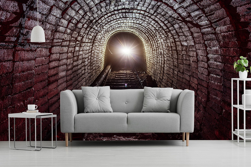 Wall mural - Impressive brick tunnel with light, decorative living room with grey sofa