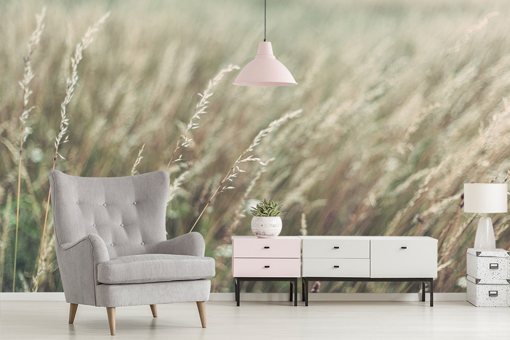 Wall mural - Bright living room with grey armchair and furniture in front of a grass landscape wallpaper