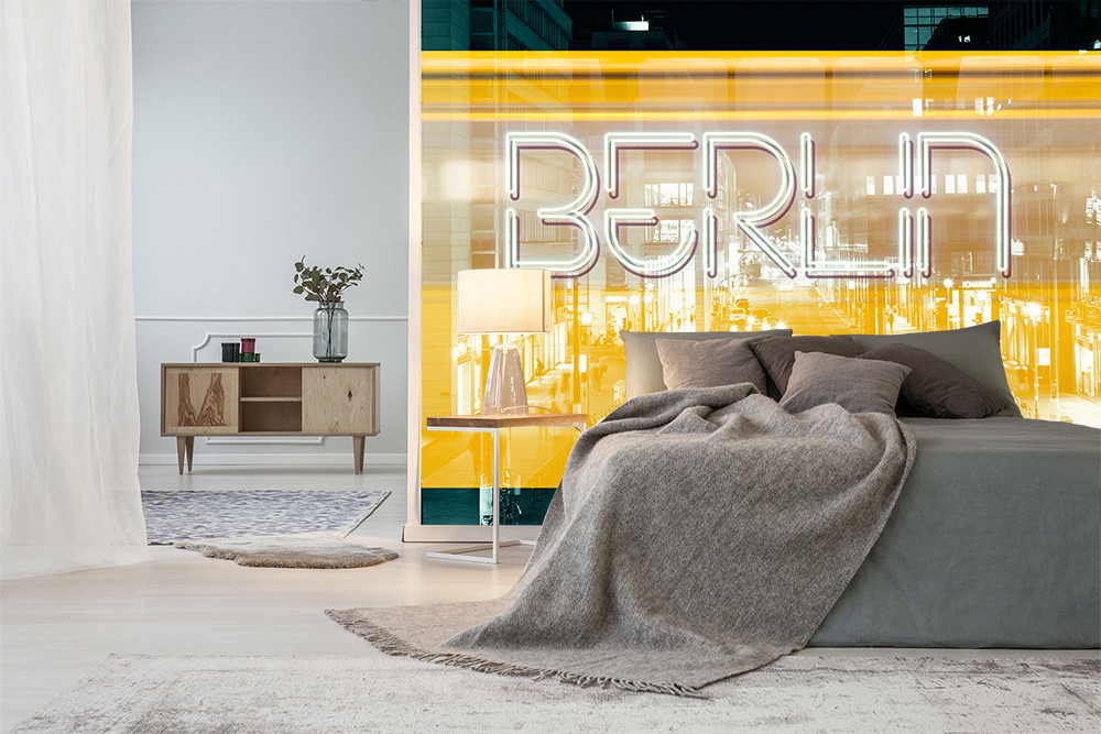 Wall mural - Bedroom with elegant furniture and large window with Berlin neon light in the background
