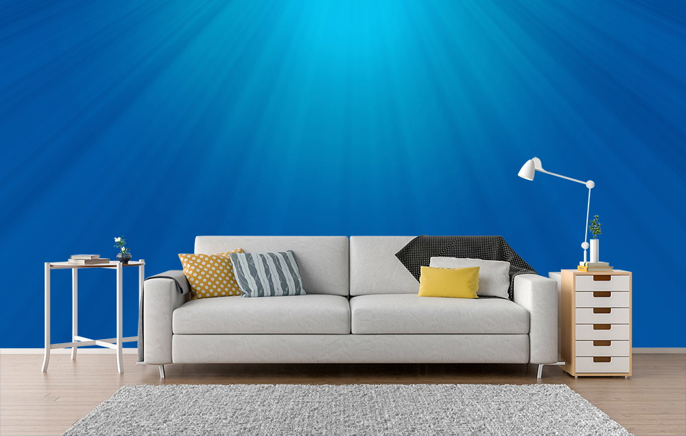 Fototapete - Helles Wohnzimmer mit blauem Wanddesign, grauem Sofa, Farbpolstern und moderner Dekoration