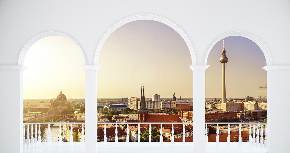 Wall mural - View of Berlin with television tower and classical architecture through three arches