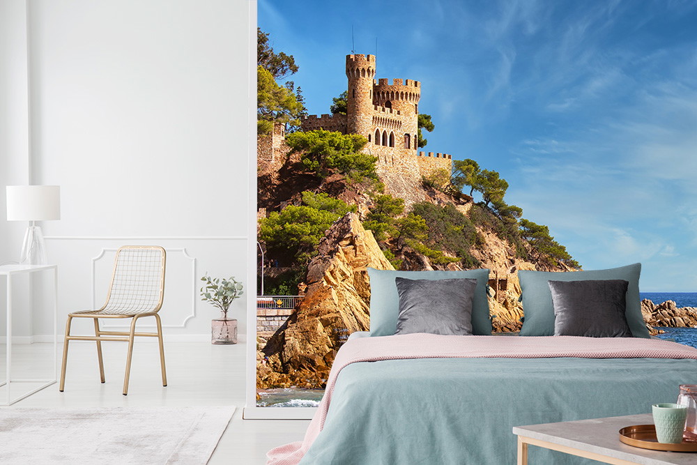 Fototapete - Schlafzimmer mit Ansicht einer malerischen Burg am Meer und blauen Himmel