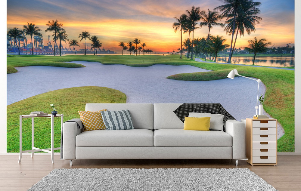 Wall mural - Living room with panorama of a golf course landscape at sunset, palm trees in the background